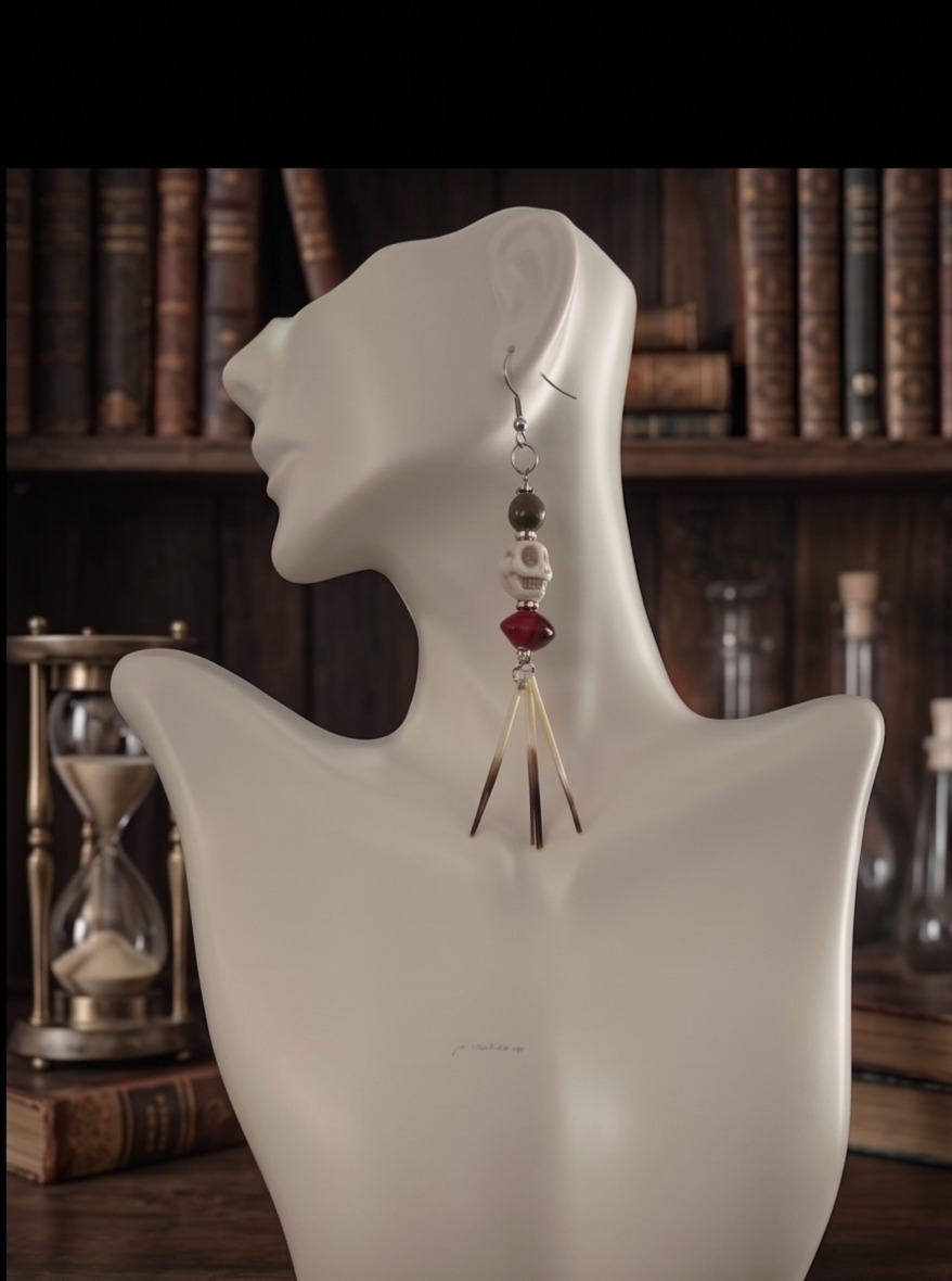 Single crimson skull and reclaimed porcupine quill earring modeled on a white display bust
