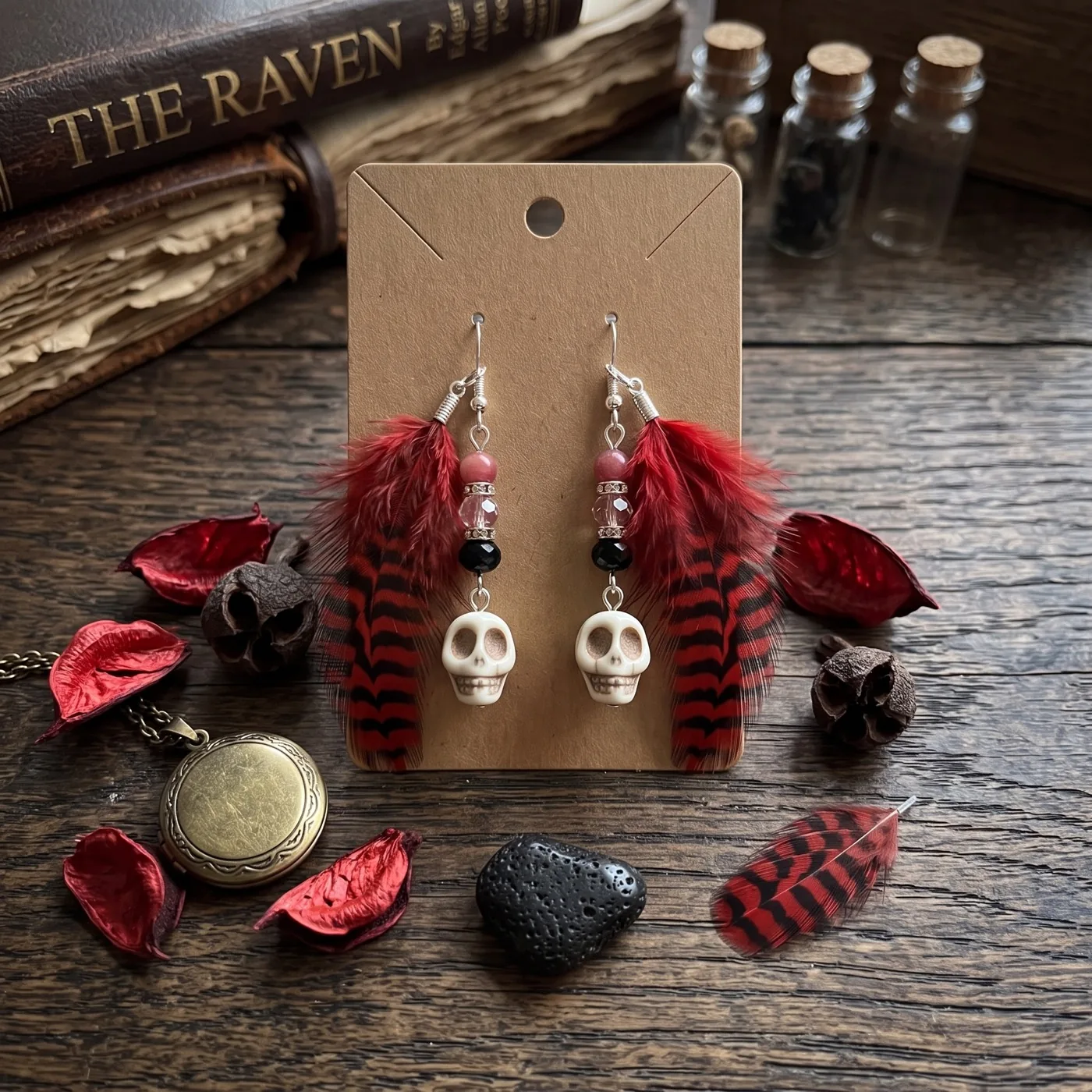 Red feather earrings with small skull charms